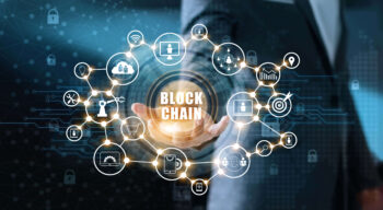 Blockchain technology and network concept. Businessman holding text blockchain in hand with icons network connection on blue security and digital connection background